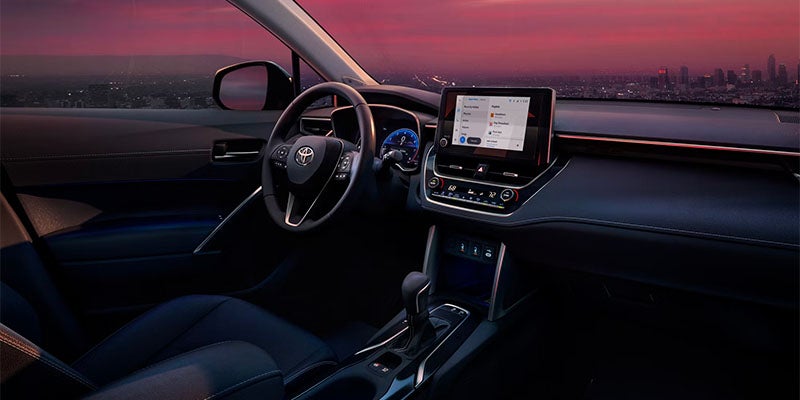 Vista interior del salpicadero y el volante del Toyota Corolla Cross con pantalla táctil